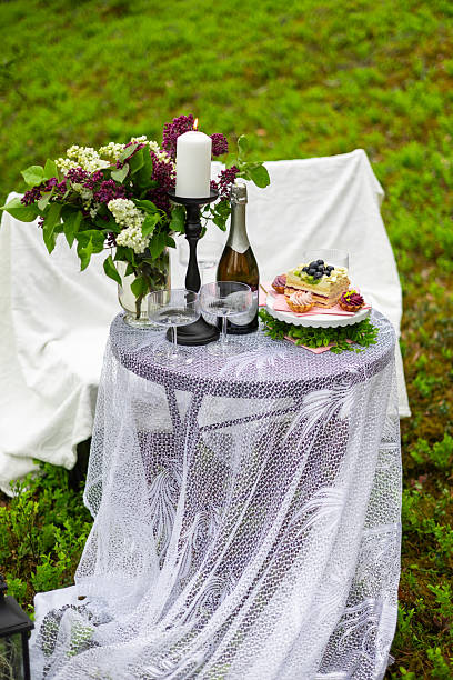 istock Elegant Picnic Table Setup with Cake and Flowers 2216803987