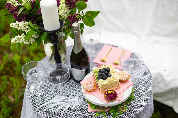 istock Elegant Picnic Table Setup with Cake and Flowers 2216803997