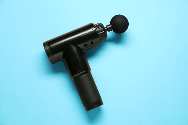 istock One black percussive massager on light blue background, top view 2216804539