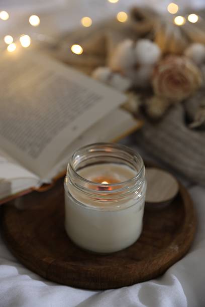 istock Burning candle on white cloth. Cozy atmosphere 2216806898