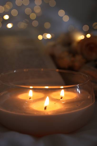 istock Burning candle on white cloth, closeup. Cozy atmosphere 2216806912