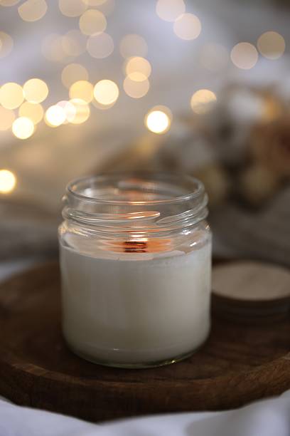 istock Burning candle on white cloth, closeup. Cozy atmosphere 2216806920