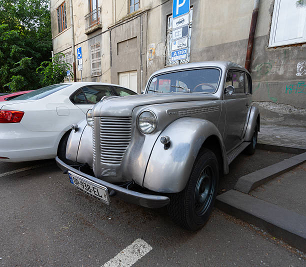 An Opel Rekord P1 (from 1950s) is parked in parking spot near Tapolca, Hungary on a sunny day