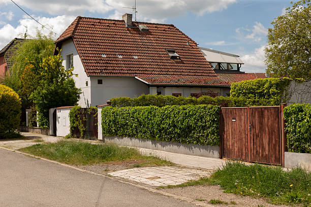 istock Charming Suburban House with Lush Greenery and a Beautiful Gate 2216808855