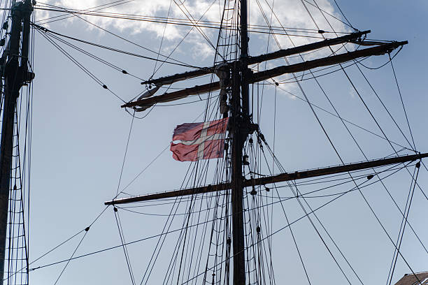 Flag of Denmark. Raised Danish flag on a ship.