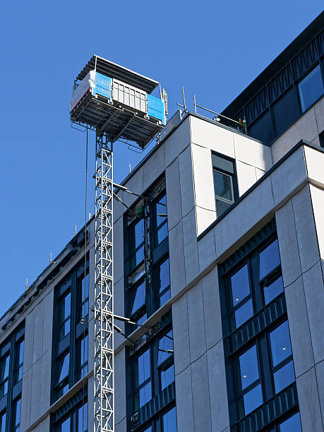istock External lift hoist at modern high rise flats being constructed 2216810764