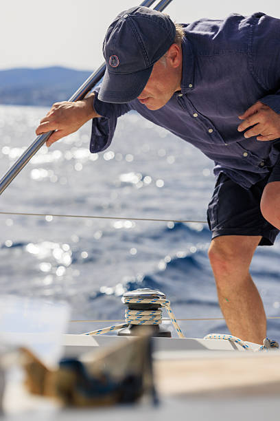 istock Mature Man Sailing in Mallorca, Spain, Adjusting Sailboat Rope 2216811236
