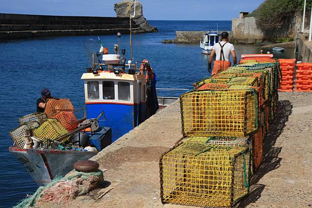 Fishermen in Portugal place the fishing baskets on the quay wall in the harbour of Vila Nova de Mile Fontes