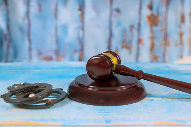 istock Gavel handcuffs on wooden surface, serious justice theme 2216818621