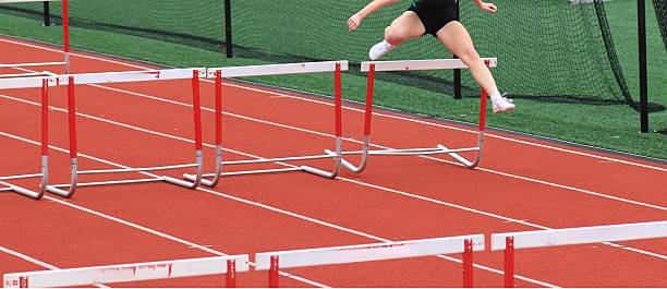istock Athlete Hurdles Over Barrier on Track During Competition 2216820840