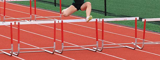 istock Young Athlete Clears Hurdles on Track During a Competitive Event 2216820871