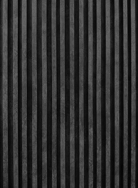 istock close up view of dark black concrete slats in vertical pattern. a textured gray surface with evenly spaced vertical stripes, possibly depicting an acoustic panel or a modern architectural detail. 2216821176