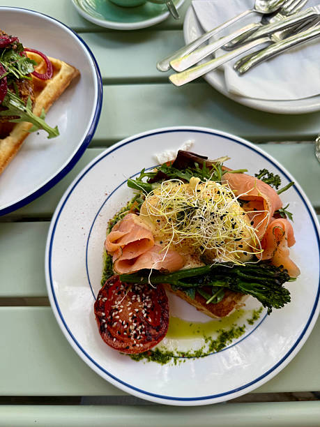 istock Gourmet brunch with poached eggs, smoked salmon and greens 2216821501