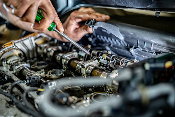 istock Mechanic Working on Engine Repair in a Car Garage Environment 2216822672