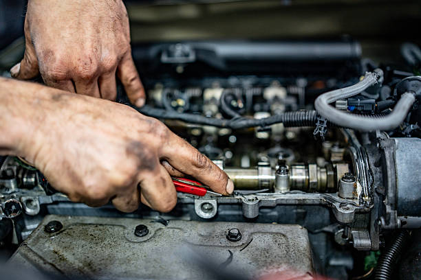 istock Mechanic Repairing a Car Engine with Precision in a Workshop 2216822680