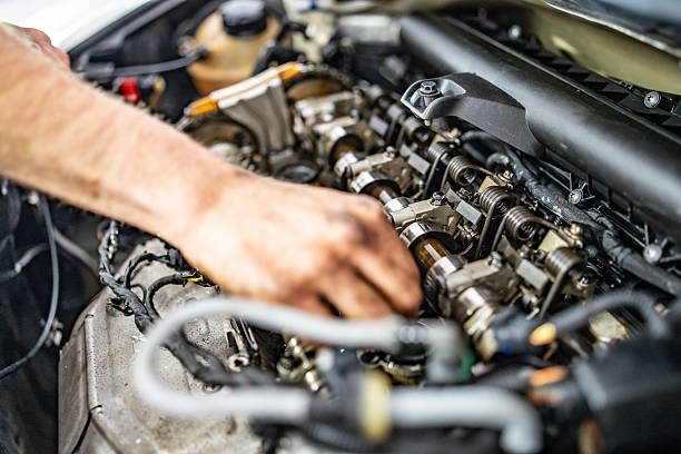 istock Mechanic Working on Engine Components in a Vehicle's Open Hood Area 2216822713
