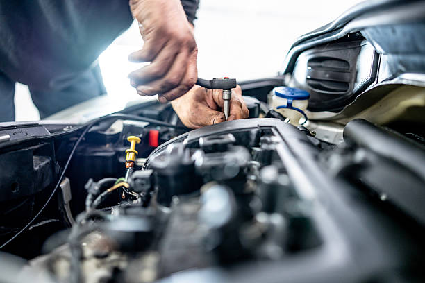 istock Mechanic Performing Repairs on a Car Engine in a Workshop 2216822729