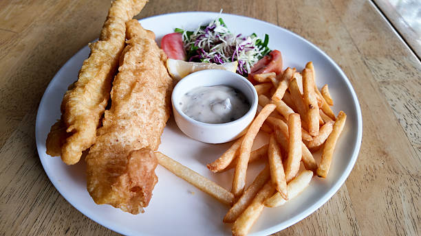 istock Crispy fish and chips served with tartar sauce and fresh salad 2216825022