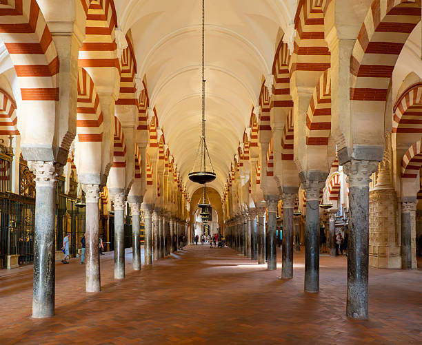 Cordoba, Spain - May 17th, 2025: Arches in the interior of the Mezquita in Cordoba, Spain.  Originally a mosque, constructed in 785, it was converted to a Roman Catholic Cathedral in 1236 during the Reconquista, the reconquest of the Iberian Peninsula, by Christian forces of Castile.