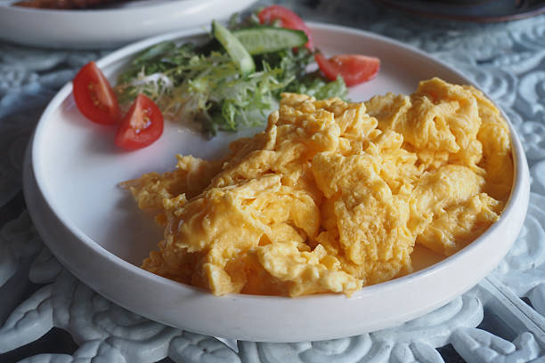 istock Soft scrambled eggs served with fresh vegetables on a plate 2216827024