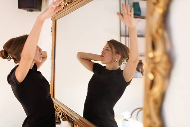 istock Woman dancing confidently in front of a large ornate mirror, showcasing self-expression in a stylish setting 2216828065