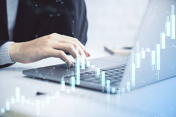 istock Business person analyzing forex market data using laptop with digital financial chart overlay on office desk background for investment strategy concept. 2216829120