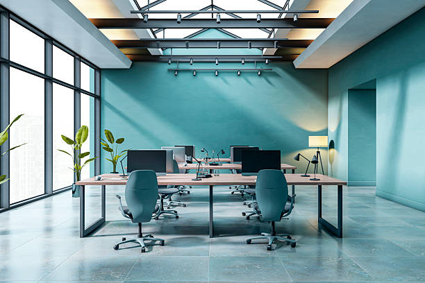 Modern empty office interior with skylight ceiling, blue walls, and minimalist desk setup in luxury corporate building workspace environment. 3D Rendering