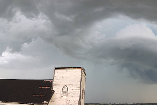 Thunderhead clouds forming behind a country church