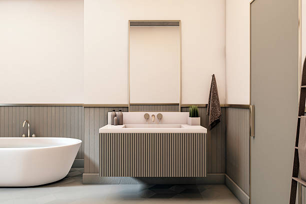 istock Modern minimalist bathroom interior with floating vanity, wall-mounted sink, and freestanding bathtub in soft neutral tones. 3D Rendering 2216829533
