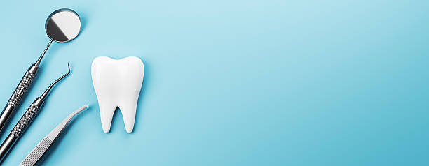 istock Dental tools and white tooth on blue background with clean layout and copyspace for dental health or clinic design template concept mockup. 3D Rendering 2216829575