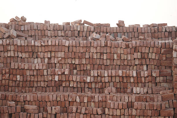 Workers are preparing a supply of bricks for upcoming building projects.