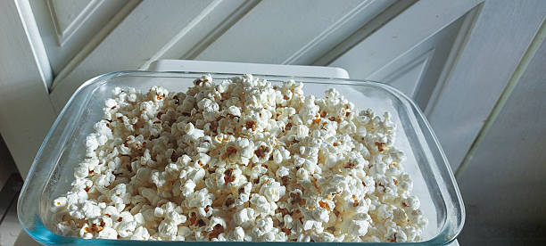istock Popcorn in a glass box on a white background 2216834994