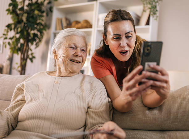 istock senior Mother and daughter using a smartphone at home 2216835250