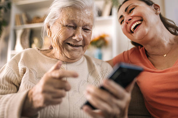 istock senior Mother and daughter using a smartphone at home 2216835318