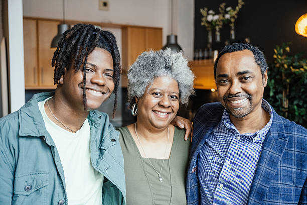 istock Real black family at home, smiling and looking at camera 2216837084