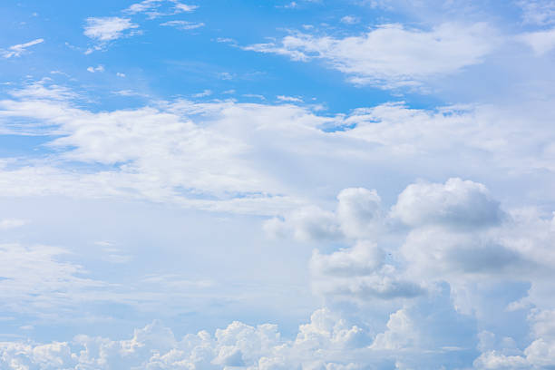 Beautiful cloud formations gather across a vivid blue sky, creating a stunning and peaceful natural backdrop.