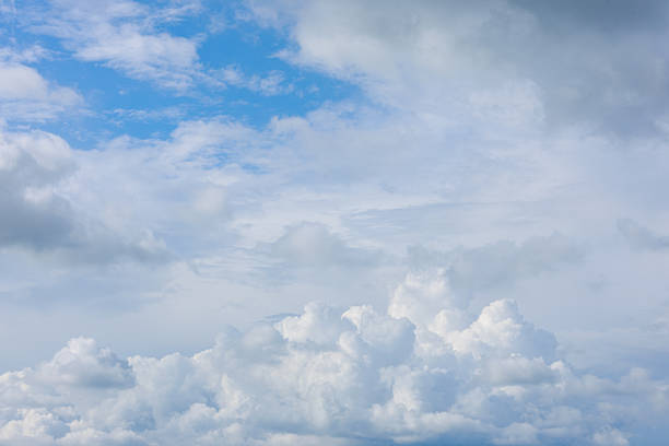 Beautiful cloud formations gather across a vivid blue sky, creating a stunning and peaceful natural backdrop.
