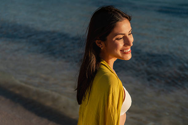 istock Coastal Charm: Woman Sunbathing at Beach 2216839402