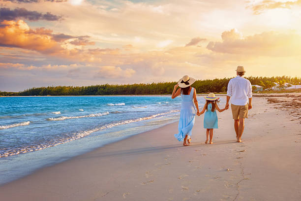 istock A family on summer holidays walks on a beach during sunset time 2216839700