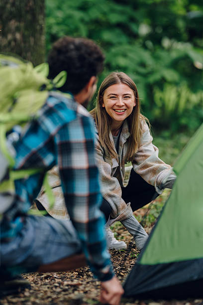 istock Hikers setting up tent in forest during camping trip 2216842563