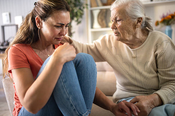istock The daughter has family problems and her elderly mother comforts her. 2216842727