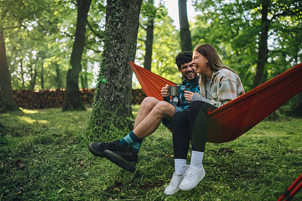 istock Couple relaxing in hammock, drinking coffee and enjoying nature 2216842766
