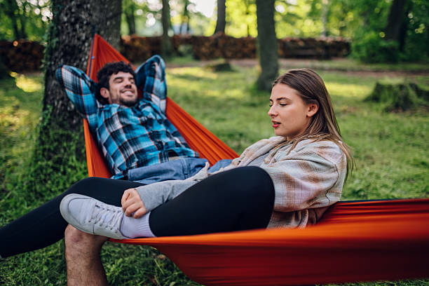 istock Young couple relaxing in hammocks at the park 2216842806
