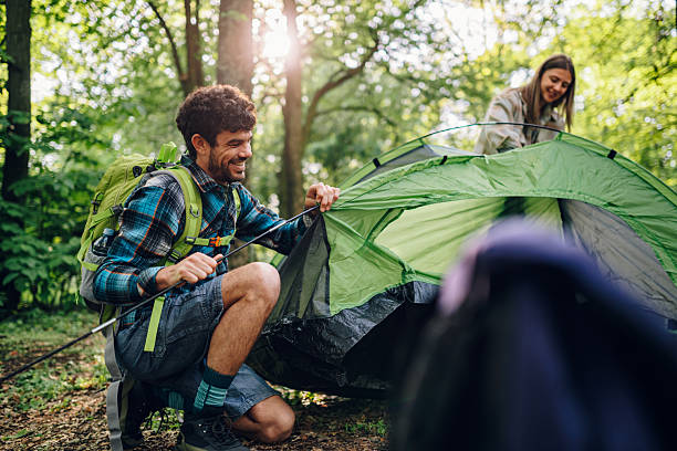 istock Hikers setting up tent in forest during camping trip 2216843566
