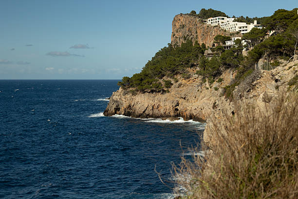 Cliff in the Mediterranean Sea on a sunny day with the horizon in the background