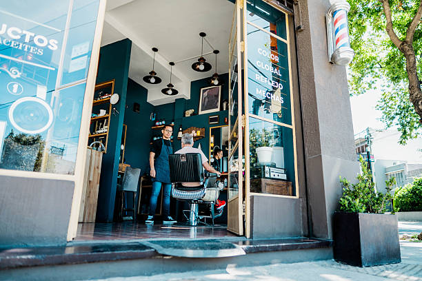 A barber shop with a gold chair and a mirror. The chair is black and has a gold trim