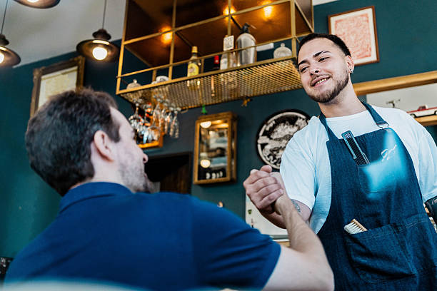 istock Barber greeting customer with a handshake in a barbershop 2216847785