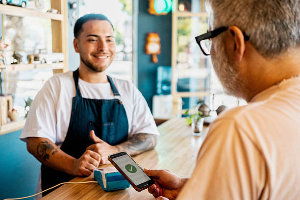 istock Barber receiving payment from a customer in a barber shop 2216848074