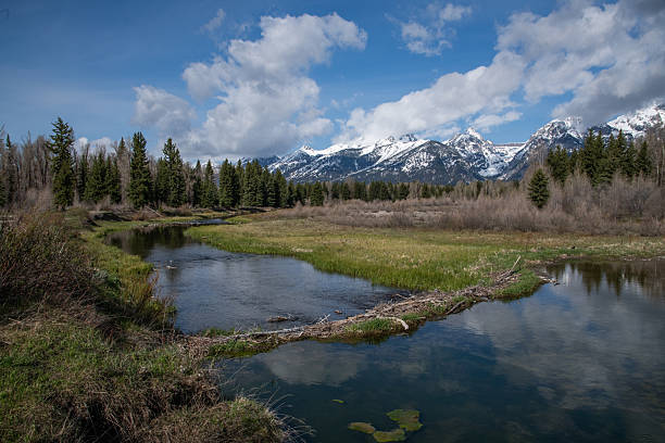 Low clouds and view of beaver dam, meadows, snake river and mountains where wildlife is abundant at Grand Teton National Park, Wyoming, United States.