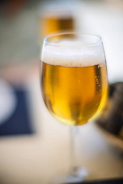 istock Golden beer in a glass with soft focus creating a warm ambiance 2216852069